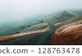 Winding Road Through Foggy Mountains 128763478