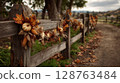 Rustic Wooden Fence Decorated with Autumnal Pumpkins and Leaves 128763484