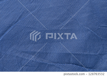 Pattern of blue cloth with holes 128763532