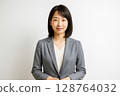 Smiling portrait of a young female university professor (white background) 128764032
