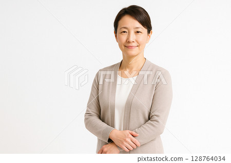 Portrait of a female professor in her 40s (white background, gentle impression) 128764034