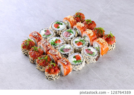 Premium Salmon Sushi Roll Set on Gray Stone Background Plate Premium Salmon Sushi Roll Set on Gray Stone Background Plate 128764389