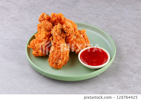 Crispy Fried Chicken Drumsticks with Sweet Chili Dip on Green Plate Crispy Fried Chicken Drumsticks with Sweet Chili Dip on Green Plate 128764425