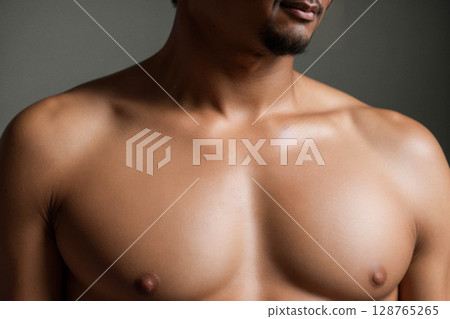 Close-Up of a Male Torso in Natural Light 128765265