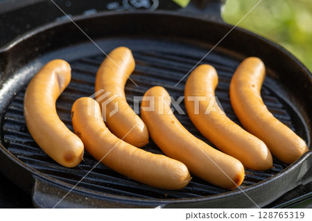 sausages on grill pan sausages on grill pan 128765319