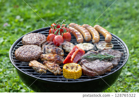 various meats and vegetables on charcoal grill 128765322
