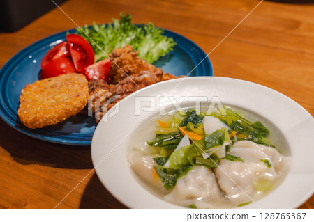 A hearty dinner of fried chicken, boiled dumplings and vegetable soup A hearty dinner of fried chicken, boiled dumplings and vegetable soup 128765367