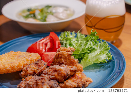 A hearty dinner of fried chicken, boiled dumplings and vegetable soup 128765371