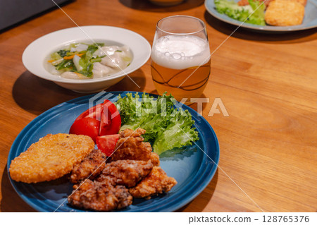 A hearty dinner of fried chicken, boiled dumplings and vegetable soup 128765376