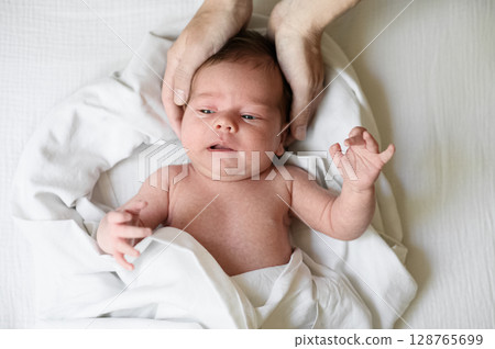 Tender Moment Between Mother and Newborn Baby 128765699