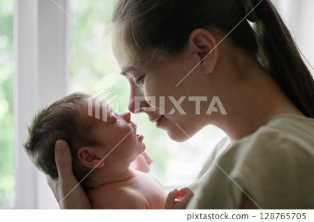 Tender Moment Between Mother and Newborn Baby 128765705