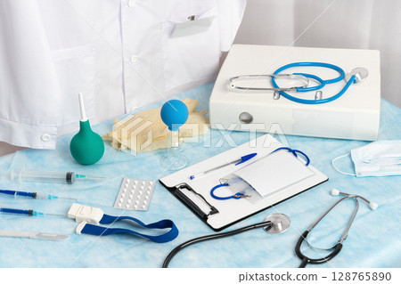 A variety of equipment, instruments, supplies and documents are available at the doctor's workplace in the medical clinic, ensuring everything is ready for emergencies and routine check-ups alike A variety of equipment, instruments, supplies and documents are available at the doctor's workplace in the medical clinic, ensuring everything is ready for emergencies and routine check-ups alike 128765890