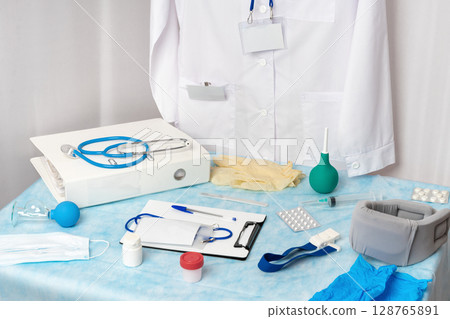 A big bunch of medical instruments, tools, supplies, equipment and documents all ready and waiting for use in the doctor's office at the medical clinic. Concepts related to healthcare and medicine 128765891