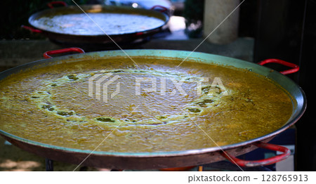 Traditional Spanish Outdoor Paella Preparation During Village Festivities 128765913