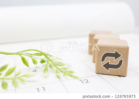 Calendar and wooden blocks illustrating the concept of recurring schedule Calendar and wooden blocks illustrating the concept of recurring schedule 128765973