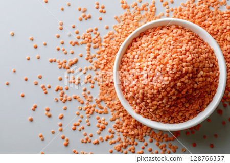 Red Lentils in White Bowl on Light Gray Background 128766357