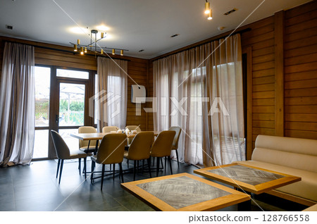 Modern interior of the room with wooden walls and furniture Modern interior of the room with wooden walls and furniture 128766558