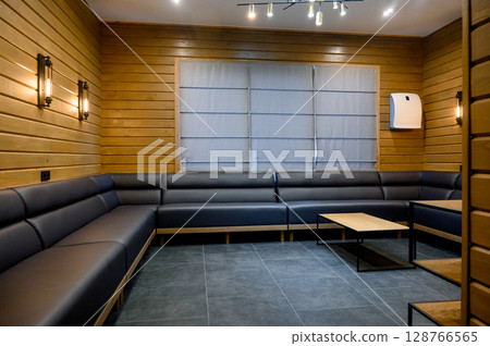 Interior with wooden walls, leather sofa and floor lamp Interior with wooden walls, leather sofa and floor lamp 128766565