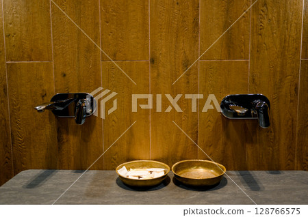 Sauna interior with wooden walls and benches 128766575