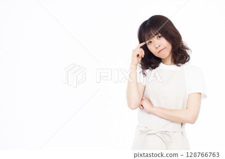 A housewife holding her head in worry A housewife holding her head in worry 128766763