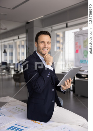Portrait of happy businessman dressed in suit hold digital tablet Portrait of happy businessman dressed in suit hold digital tablet 128766970