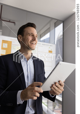 Successful businessman or employee using tablet in modern office Successful businessman or employee using tablet in modern office 128766993