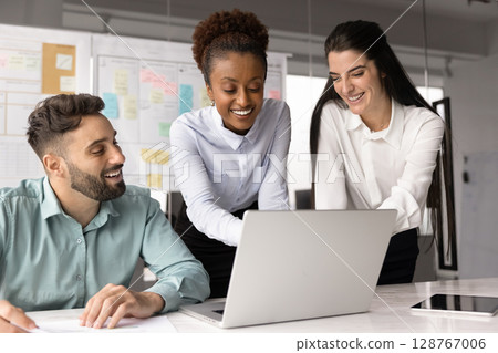 Multiracial teammates collaborate on project presentation using laptop 128767006