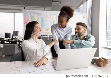 Workmates fist bumping, start or accomplished teamwork successfully 128767107