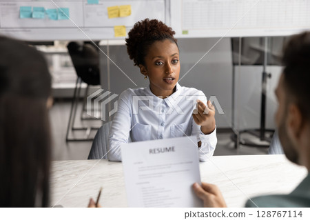 Young African woman answers questions during job interview 128767114