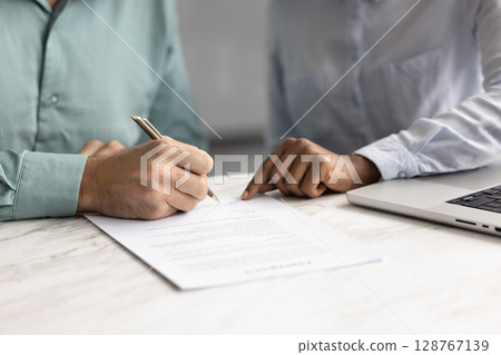 Man holding pen and signing lease or rental agreement Man holding pen and signing lease or rental agreement 128767139