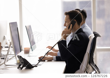 Man assisting to client remotely, providing support over phone Man assisting to client remotely, providing support over phone 128767226