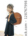A first grade girl walking to school with her school bag on 128767998