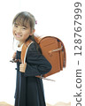 A first grade girl walking to school with her school bag on 128767999