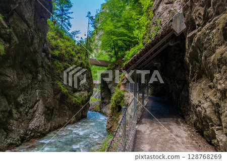 Partnachklamm Gorge in Garmisch-Partenkirchen, Bavaria. Towering cliffs, turquoise waters, and a dramatic trail offer an unforgettable natural experience in southern Germany. 128768269
