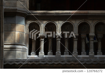 Sunlight casts dramatic shadows across stone columns and ornate stone balustrade. Sunlight casts dramatic shadows across stone columns and ornate stone balustrade. 128768272