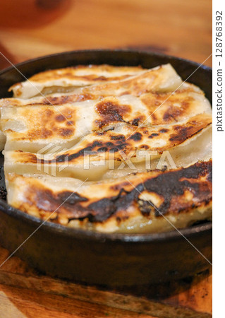 Iron pot stick dumplings 128768392