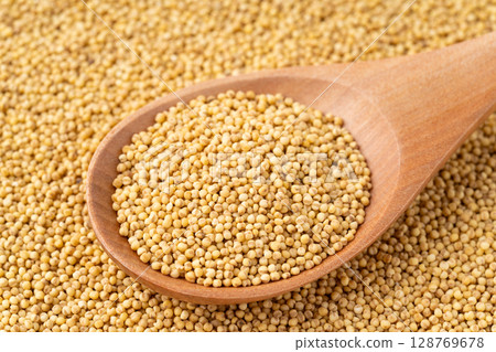 Close-up of yellow mochi millet on a spoon 128769678