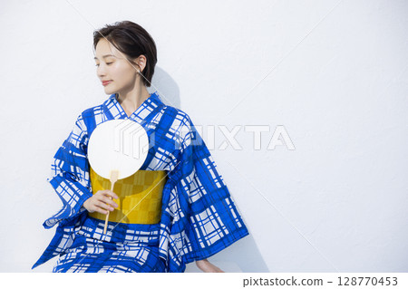 A woman in a yukata A woman in a yukata 128770453