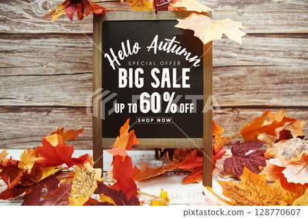 Hello Autumn Big Sale 60% text with maple leaf decoration on wooden background Hello Autumn Big Sale 60% text with maple leaf decoration on wooden background 128770607