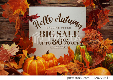 Hello Autumn Big Sale 80% text with maple leaf decoration on wooden background 128770612