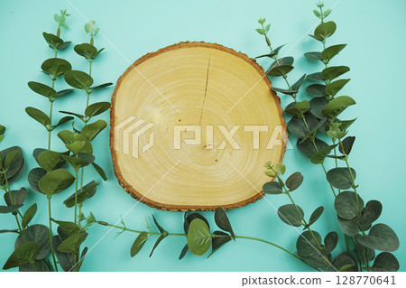 wooden podium product display stands flat lay with leaves top view on blue background 128770641