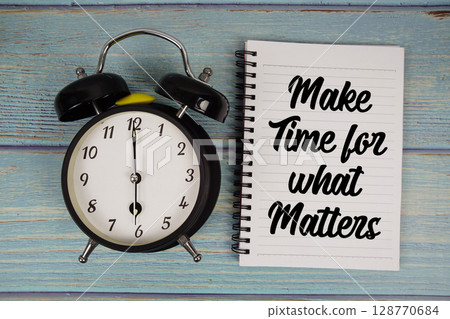 Make Time for what Matters text written on notepad with alarm clock on wooden background 128770684