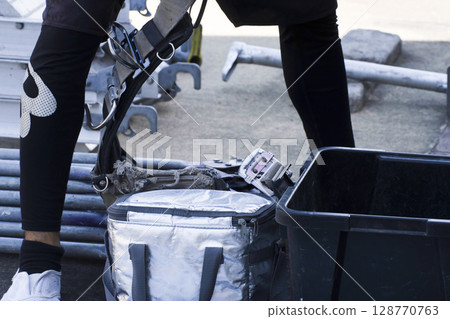 Workers assembling scaffolding 128770763