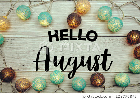 Hello August text with LED cotton balls decorated on wooden background Hello August text with LED cotton balls decorated on wooden background 128770875