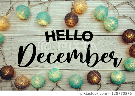Hello December text with LED cotton balls decorated on wooden background Hello December text with LED cotton balls decorated on wooden background 128770876