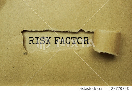Risk Factor message written on craft paper with torn paper background Risk Factor message written on craft paper with torn paper background 128770898