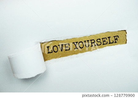 Love Yourself message written on craft paper with torn paper background 128770900