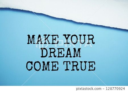 Make Your Dream Come True message written on blue paper with torn paper background 128770924