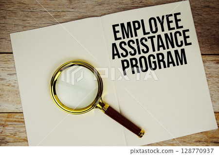 Employee Assistance Program text written on chalkboard with alarm clock on wooden background 128770937