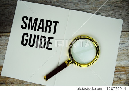 Smart Guide text written on chalkboard with alarm clock on wooden background Smart Guide text written on chalkboard with alarm clock on wooden background 128770944